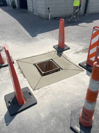 A precise square opening cut into a concrete slab in the Salt Lake area